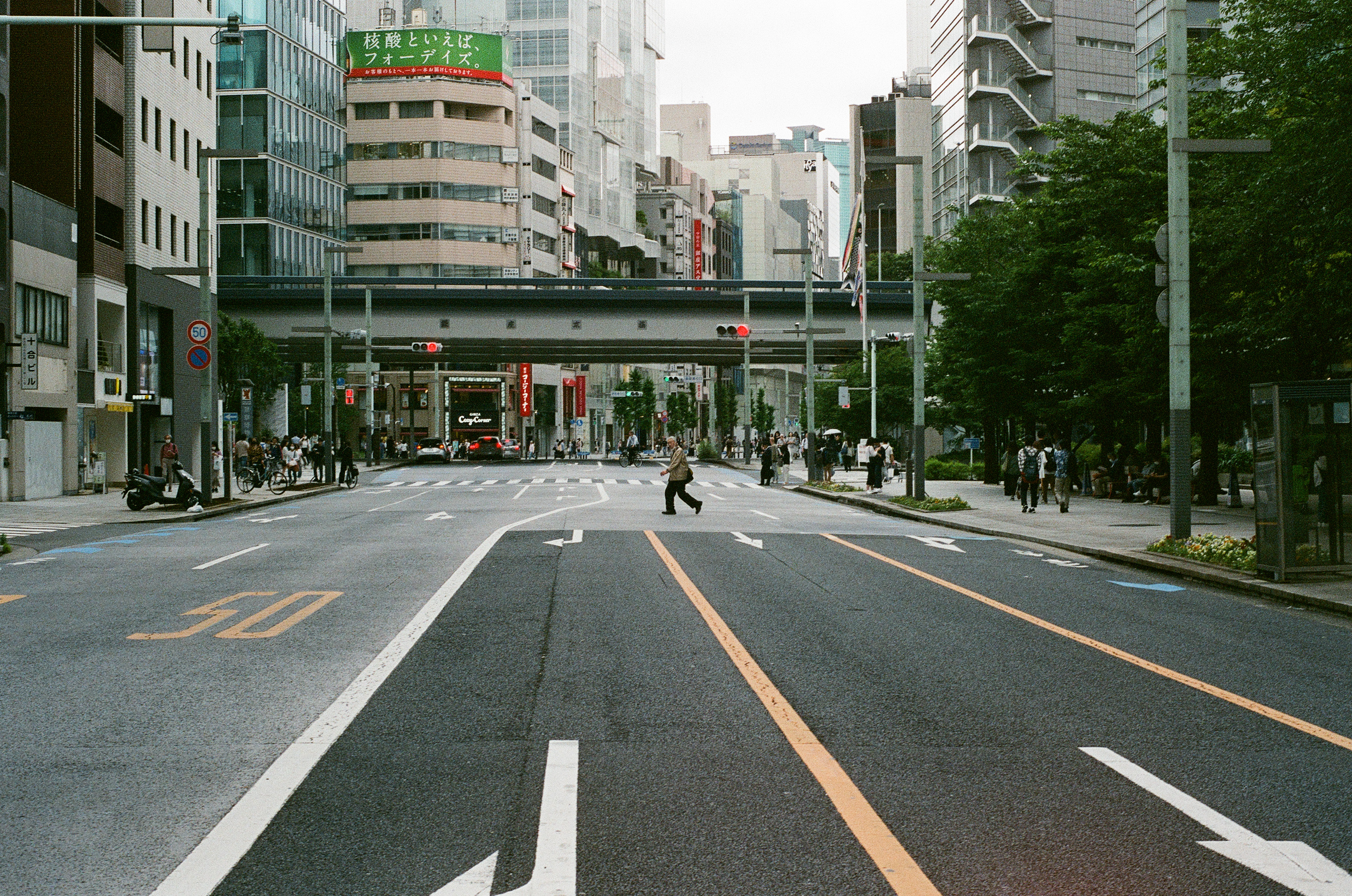 Shinagawa - A man walks across the street on a gloomy morning.